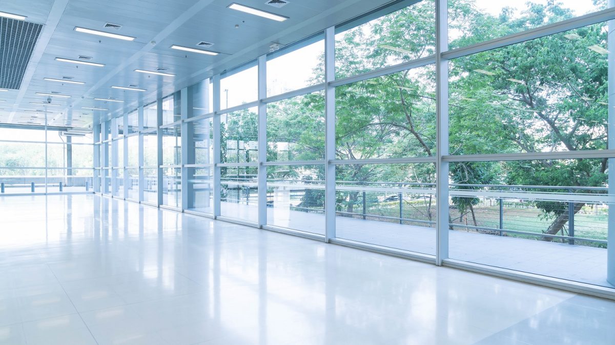kancelarijskog prostora - blurred abstract background interior view looking out toward empty office lobby entrance doors glass curtain wall with frame 1200x675 - How To Find Good Office Space in Belgrade? (SIZE)