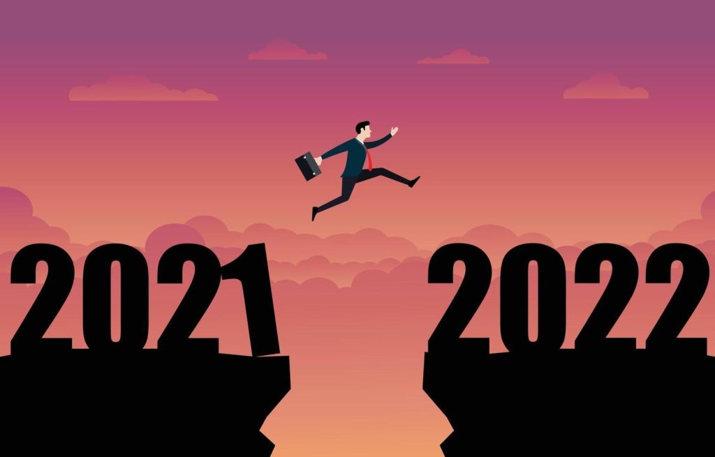 a business person jumping to the new year 2022 vector1